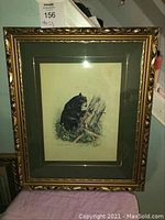 Full view of framed black bear print depicting bear stealing honey from a tree trunk, shows overall condition and frame details.
