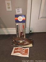 Photo showing Pocket Fisherman in original box with storage bag and attached reel and order form.