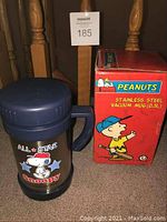 Photo of Snoopy All Stars vacuum mug with box, showing mug design and box details.