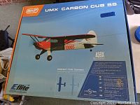 Box displaying the E-flite UMX Carbon Cub SS remote control airplane with key features and image of the aircraft.