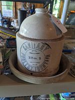 Front and side view of the vintage stoneware poultry fountain with visible "Sanitary No. 1 Poultry Fountain" marking on main jug.