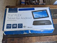 Original box showing product information and image of the tablet with detachable keyboard.