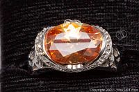 Close-up of the orange faceted crystal set in 925 silver ring showing the detailed setting and design.