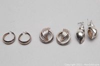 Photo showing all three pairs of 925 silver earrings laid flat with closures visible, showcasing the designs and size differences.