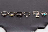 Six 925 silver rings displayed on black background showing front view of all rings with various stones and details.