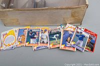 Top view of assorted NHL hockey cards fanned out showing various players in different team uniforms and colors, some cards worn with soft edges.