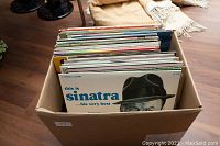 Top-down view of a box filled with over 40 vintage vinyl albums, prominently showing Sinatra album cover.