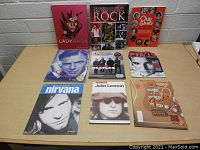 Frontal overview of all nine books laid out on table showing front covers and titles