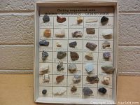 Front view of vintage educational rocks, minerals, and gemstones display with 36 specimens arranged in a grid and labeled.