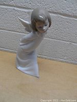 Front profile of the Lladro angel figurine showing full form, wings, and gown.