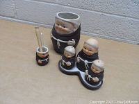 Photo shows entire set of Goebel monk figurines including largest monk container, small utensil cup, and three condiment shakers on base.