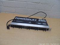 Front view of Behringer Powerplay Pro HA400 headphone amplifier showing control knobs, input/output jacks, and power switch.
