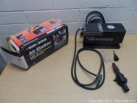 Overall view of Black & Decker Air Station compressor and attachments with original box.