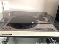 Full front view of turntable with lucite dust cover closed