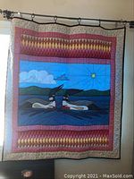 Full front view of quilt hanging on rod showing overall design and condition