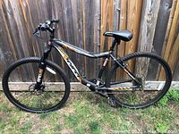 Side view of full mountain bike displaying frame, wheels, saddle and handlebars