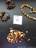 Overview showing two cluster bracelets, chip-bead necklace and loose strand of beads