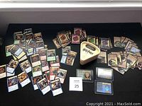 Photo showing a wide spread of Harry Potter trading cards laid out with various characters and scenes along with the triangular sealed Trivial Pursuit game box