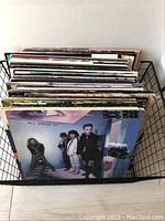 Overview of vinyl LP record lot in black wire rack