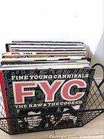 Wire basket filled with vinyl record sleeves, front cover showing Fine Young Cannibals - The Raw & The Cooked