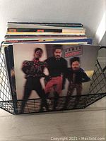 Vinyl records visible in wire basket with Cameo "Word Up!" front cover showing three band members in black and red outfits