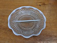 Top view of the divided glass relish bowl showing hobnail texture and ruffled moonstone opalescent edge with divider in place.