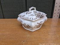 Square Victorian Staffordshire ceramic dish with brown transfer floral design and lid, displayed closed on wooden surface.