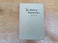 Front cover of 'The Book of Perennials' showing cloth hardcover with title and author name.