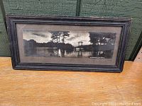 Front view of antique framed landscape photograph showing Sluice Pond scene with trees, pontoon bridge, and water reflections.