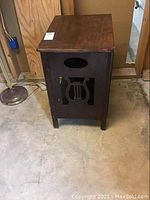 Front angle showing the lyre-shaped cutout design and overall wear on wooden table.