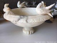 Front and side view of alabaster centerpiece bowl with bird figures on rim