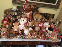 Overview of the lot showing an extensive collection of various sized and colored stuffed bears and small bear figurines.