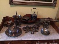 Group of all items including brass cannon, silver plated tableware pieces