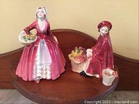 Front view of both Janet and Bonnie Lassie figurines on display