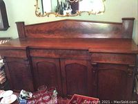 Overall front view of sideboard showing raised back bar and four doors