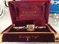 Watch displayed in open red velvet Bulova presentation case