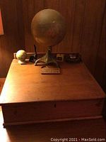 Front view of wooden writing desk box with accessories on top
