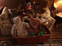 Wide shot of wooden cradle filled with multiple Gund teddy bears of various sizes