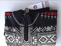 Folded black wool sweater showing zipped collar and Fair Isle knit.