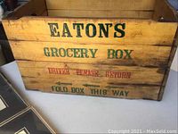 Front and side of wooden Eaton's grocery crate showing folding mechanism and printed lettering