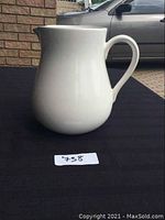 Front angled view of the large white ceramic jug showing the handle and spout.