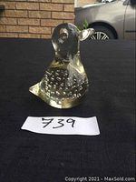 Blown glass duck figurine with bubbles inside, viewed from one side showing detailed bubbles in the body and the head shape.