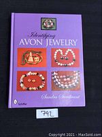 Front cover of the 'Identifying Avon Jewelry' book showing the title, author, publisher and jewelry images
