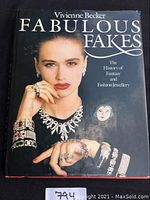Front cover of 'Fabulous Fakes' book shows a model wearing multiple pieces of fashion jewelry.