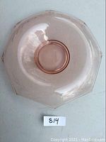 Top view of cornflower pink depression glass bowl, showing octagonal scalloped edges and central circular area.