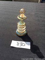 Front view of the Egyptian blown glass perfume bottle with stopper, showing the gold trim and glass structure.