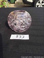 Front view of pale pink round cut crystal vase with geometric pattern details.