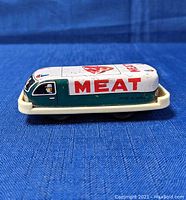 Side view showing the length, green and white color scheme, MEAT text, and 'Made in Japan' marking on the lower side.