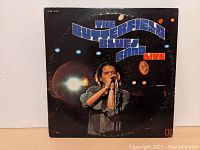 Front album cover depicting Paul Butterfield performing on stage with the band, with prominent album title text 'The Butterfield Blues Band Live'.