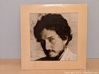 Front cover of Bob Dylan's 'New Morning' vinyl record album featuring close-up photo of Bob Dylan's face.